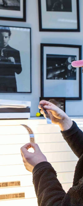 Photography student Looking At Negatives